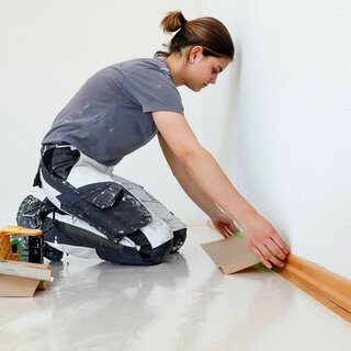 Malerin beim Abkleben