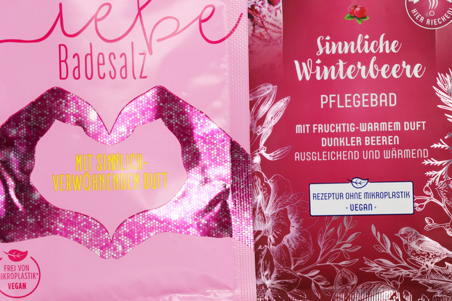 Nahaufnahme von zwei pink gestalteten Sachets für Badesalz und Pflegebad mit metallisch glänzenden Veredelungselementen